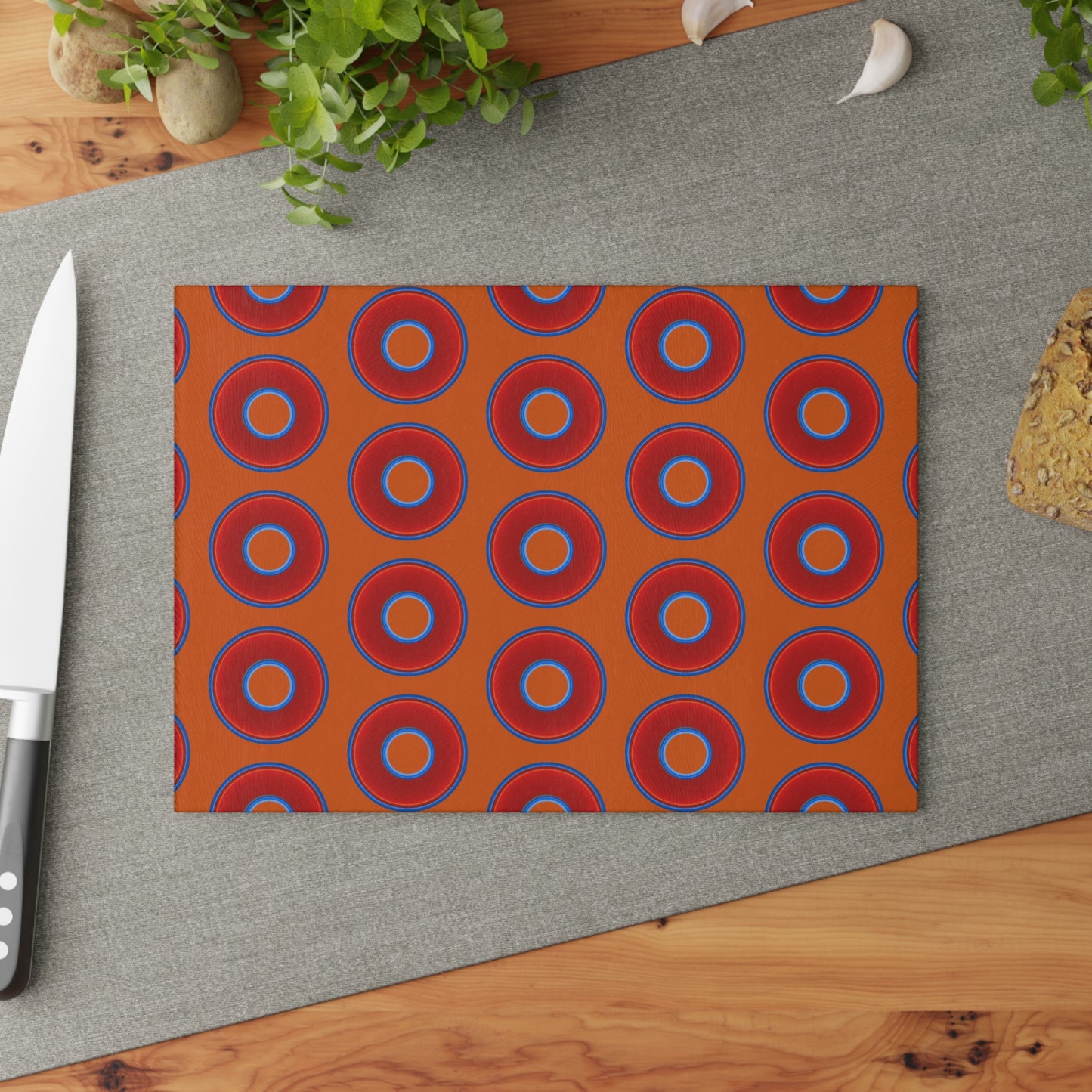 My Friend's Cutting Board - vivid red donuts w/dark orange background